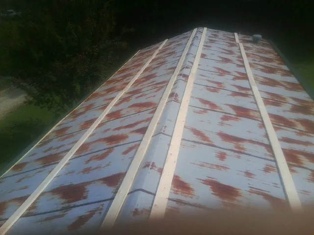 Rusted metal roof panels with new wood purlins before replacement — Storm Damage Roof Repair in Aldie by Roofing Brothers