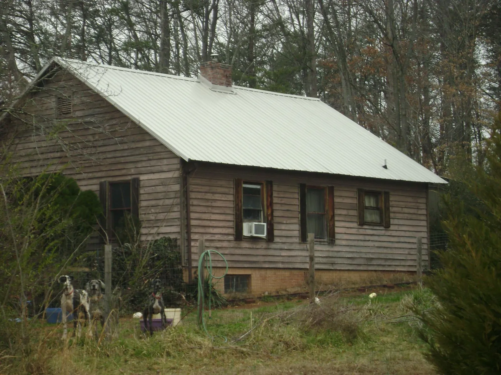 White metal roof on an old wood sided farmhouse, from a Metal Roof Installation job in Aldie